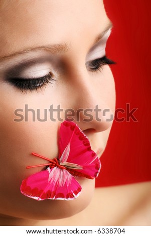 beauty portrait of a beautiful young woman with a butterfly on her face