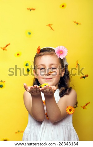 smiling beautiful young girl with falling flowers at spring