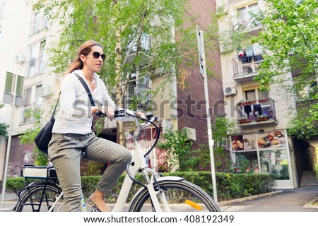E-bike commuter, riding through a city block