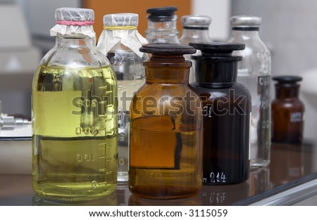 Bottles with medicinal solutions on a glass medical table