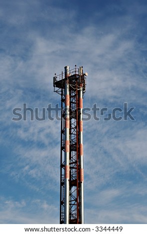 Tower of cellular communication on a background of the blue sky with clouds