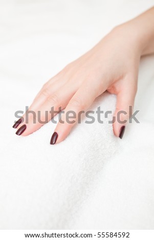 Female hand on a white terry towel