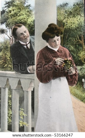 UK-CIRCA 1908: Victorian romance - loving couple on a  hand-tinted photograph postcard, circa 1908