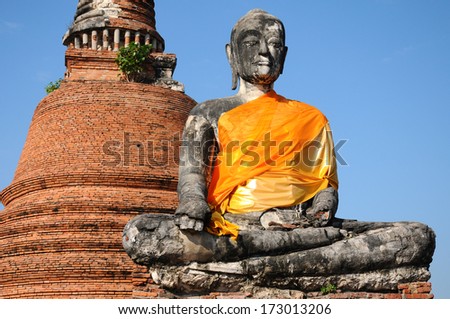 ruins statue buddha with pagoda background, Ayutthaya Historical Park, Thailand