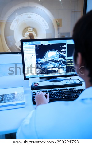 veterinarian doctor with MRI computer control take with blue filter