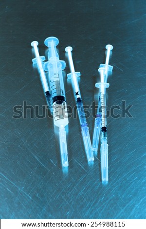 Syringes of different size take with blue filter