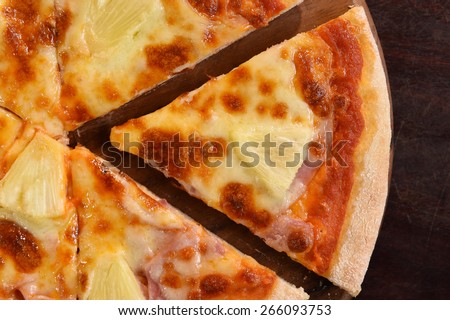 Hawaiian Pizza , pineapple , ham and cheese on the wooden background