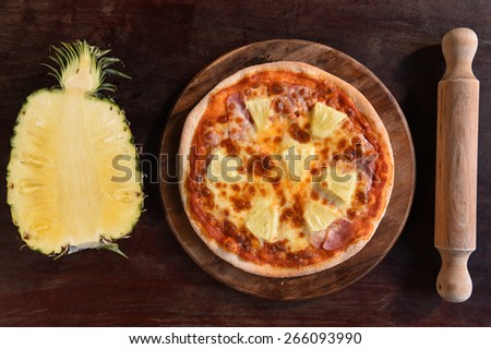 Hawaiian Pizza , pineapple , ham and cheese on the wooden background