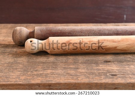 Wooden rolling pin on wooden board