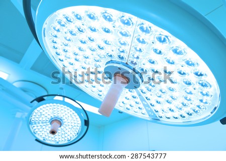 Two surgical lamps in operation room take with blue filter