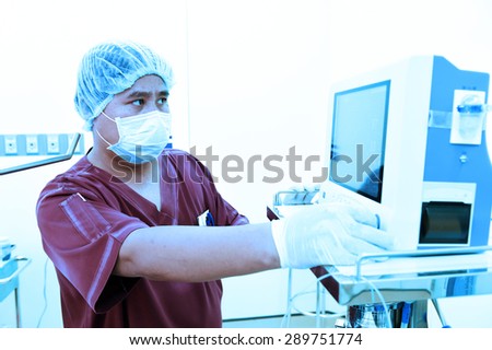 veterinarian assistant in operation room take with art lighting and blue filter