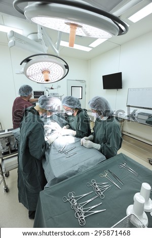 group of veterinarian surgery in operation room take with selective color technique and art lighting
