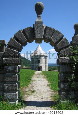 An arched vista of a romantic medieval garden pavilion (called by the locals The devilâ€™s tower).