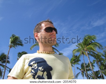 A handsome young man in a tropic environment.