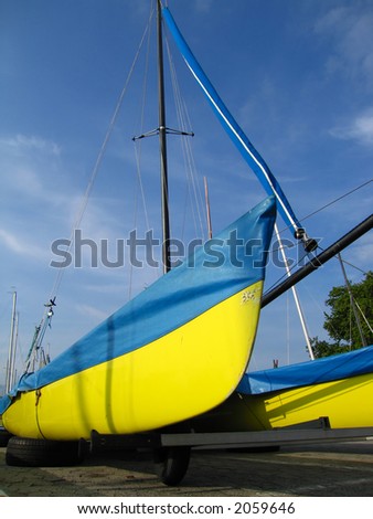 A colorful sailing boat parked ashore for the winter.