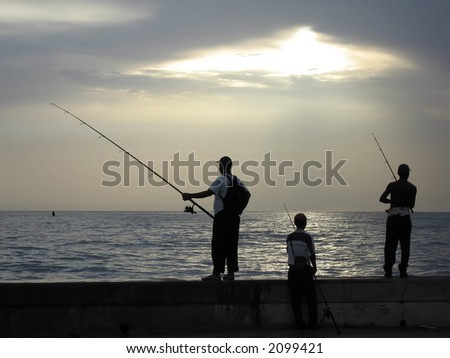 Three men fishing in the evening light.