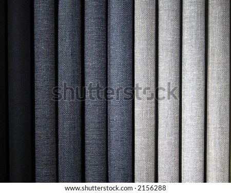 A stack of gray colored book bindings.