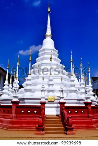 A white wat in Chiang Mai, Thailand with red stairs