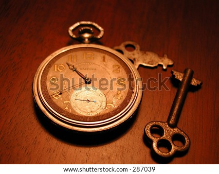 Photo of an old watch, keys, and money.