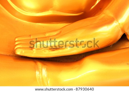 Hand of golden Buddha statues in temple.