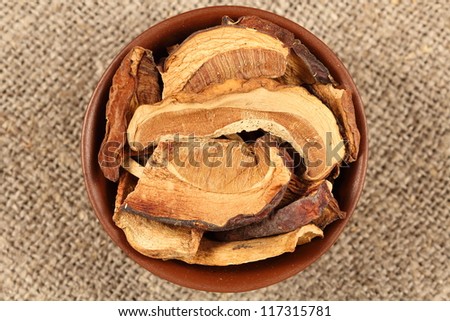 cut white dried mushrooms in a wooden bowl on bagging