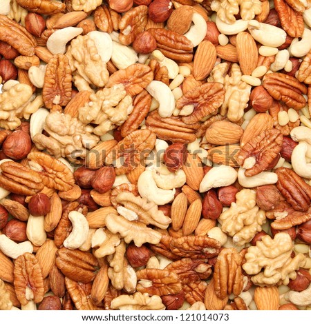 background of mixed nuts - pecans, hazelnuts, walnuts, cashews, almonds, pine nuts, pistachios
