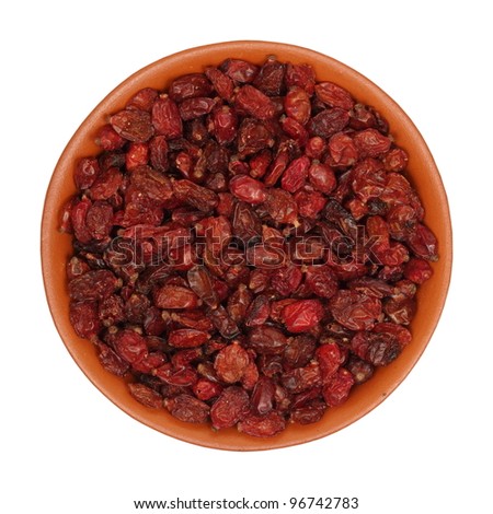 dried, red barberry, in a clay bowl, isolated, white background, texture