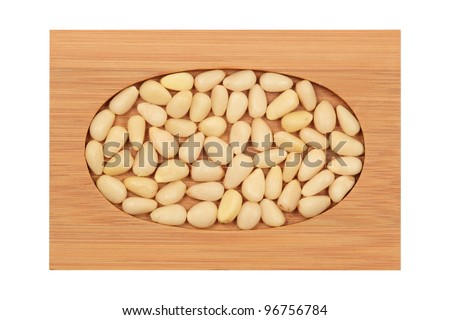 peeled, pine nuts, on a bamboo board, isolation, white background, texture