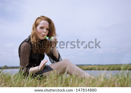 Girl blowing bubbles in the wind