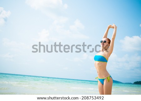 Young woman at beautiful tropical beach enjoying the sun