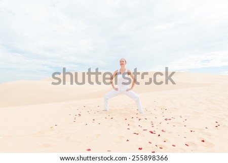 Young woman practicing yoga in the desert
