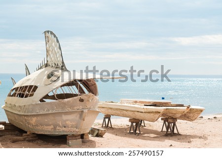 Old deserted fishing entertainment boats on the beach of Red Sea