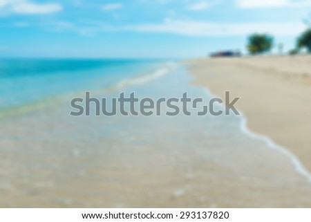 Tropical island beach with waves of clear turquoise water blur background