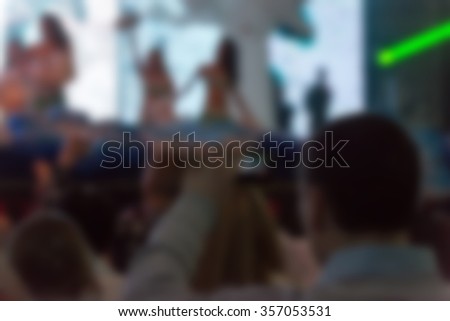 Blur background of people hanging out at the concert