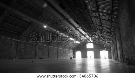 Large empty hangar with light going through the windows