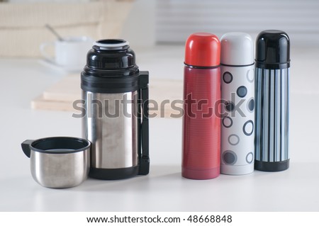 Set of vacuum flasks on a kitchen table