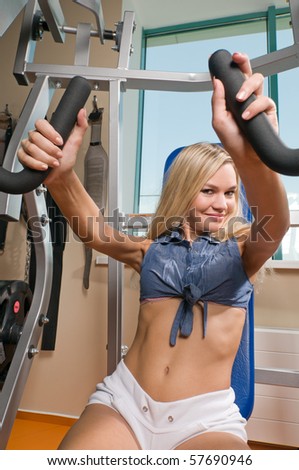 Beautiful blond girl at the health club practicing
