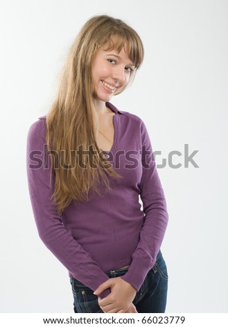 Beautiful young woman at studio over plain background