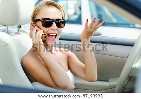 Lady on the phone with lots of emotions while driving
