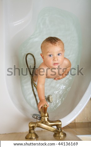 stock photo little boy taking the shower