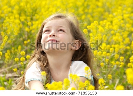 Young Girl Looking to the Heavens in a Field of Yellow Flowers