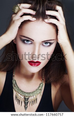 Brunette model touching head, high end fashion portrait