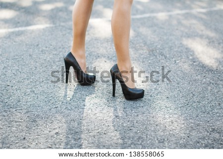 Sexy female high heeled black shoes on the way