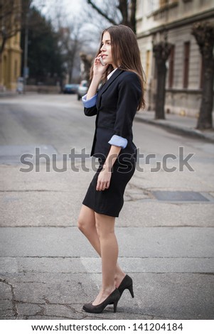 Brunette real estate agent woman calling, outdoor