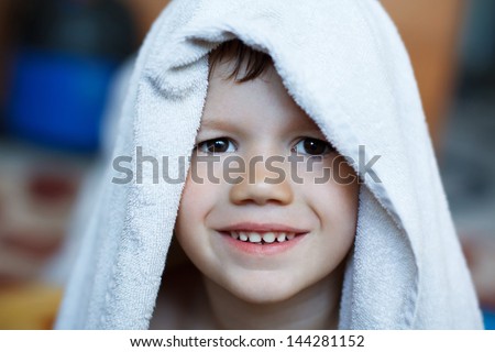 Cute child dry with towel, teeth smile