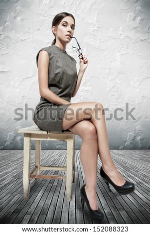Attractive brunette woman sitting on stool