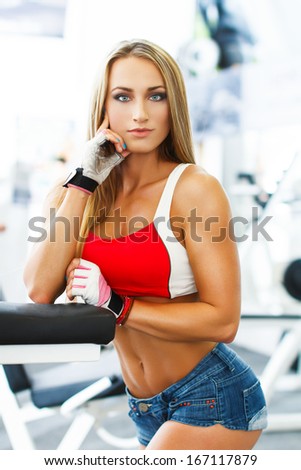 Fitness model posing in gym