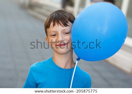 Little boy with blue air balloon, outdoor portrait