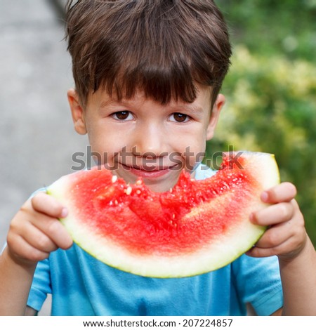 Little cute caucasian boy holding melon, outdoor portrait