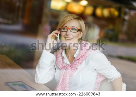 Happy young manager call by smartphone in restaurant